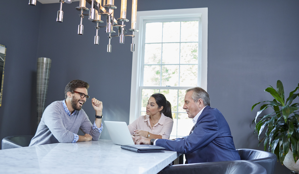 Three real estate agents having a meeting